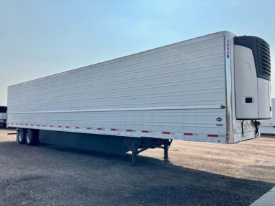 Utility reefer trailer with a refrigerated unit at the front showing a clean silver metal exterior and dual rear wheels.