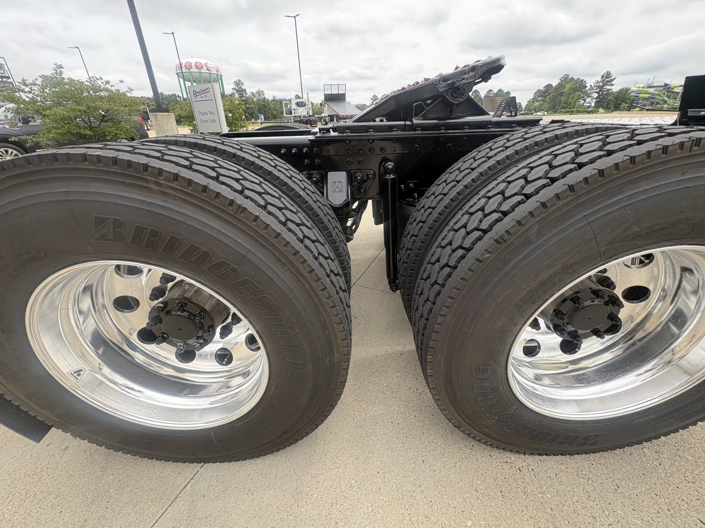 Mack PI64T truck dual rear wheels view showing polished chrome wheels and dual tires.