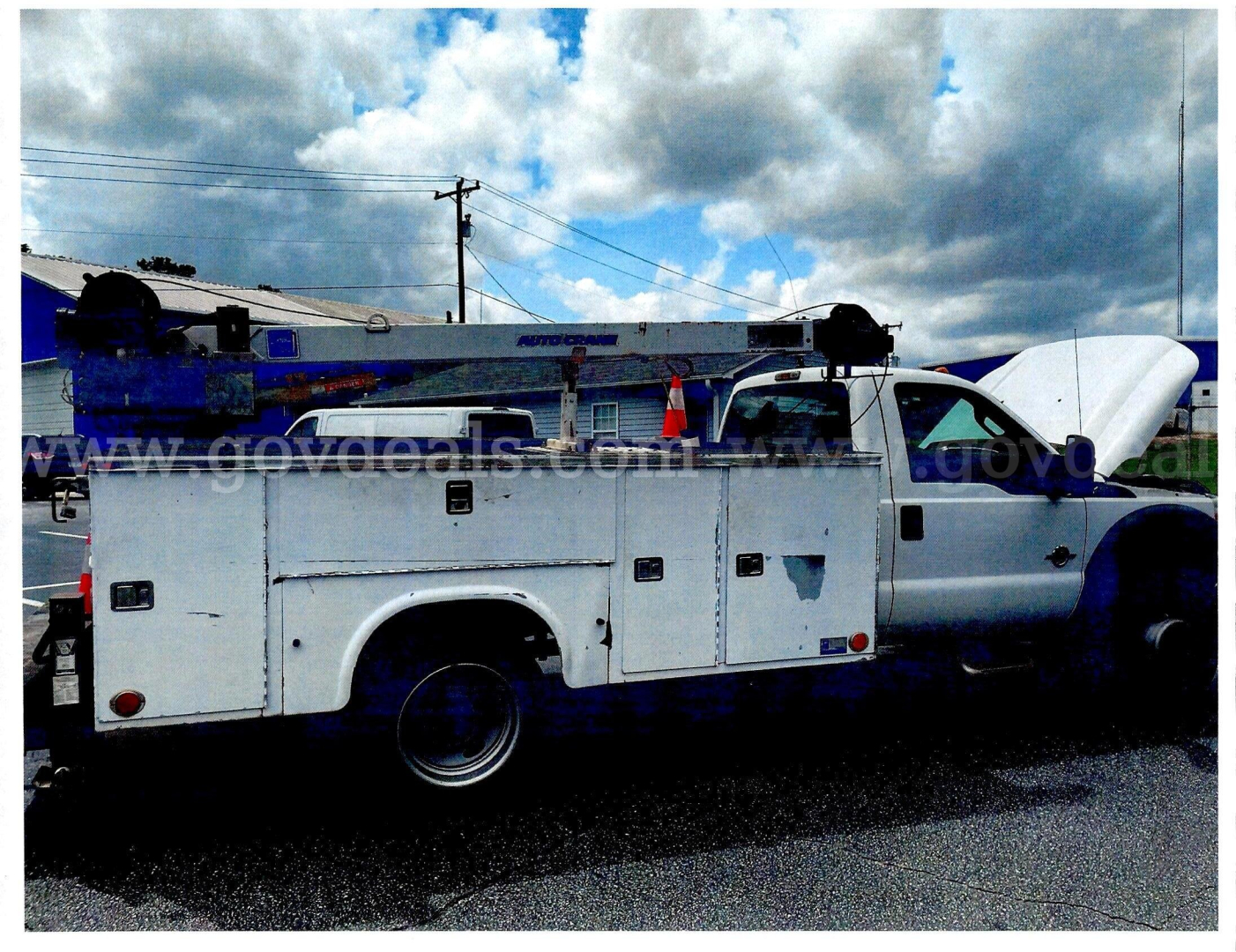 Utility/service truck with open hood showing front of Ford F-450 SD utility body compartments and dual rear wheels.