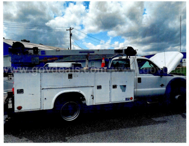 Utility/service truck with open hood showing front of Ford F-450 SD utility body compartments and dual rear wheels.