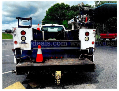 Tow rear view of a service/utility truck bed with a hitch, toolbox, and traffic cones; visible text on the photo includes 'www.govdeals.com' watermark across the center. No other legible labels or numbers.