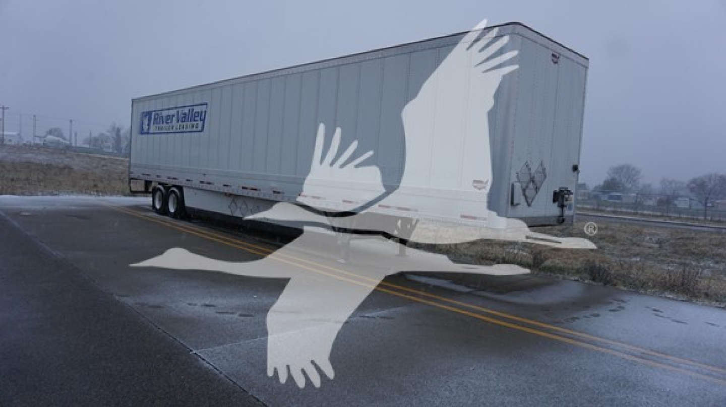 Trailer side showing Wabash dry van with logo and rear doors; some text maybe on side panel but not legible due to watermark.