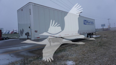  trailer with Wabash logo showing side doors and rear doors; text visible includes 'Wabash', 'Dry Van' style and trailer number '0004' on the corner; side shows manufacturer's markings and a blue logo.