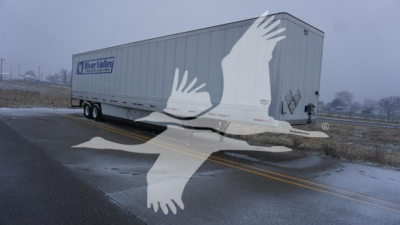 Trailer side showing Wabash dry van with logo and rear doors; some text maybe on side panel but not legible due to watermark.