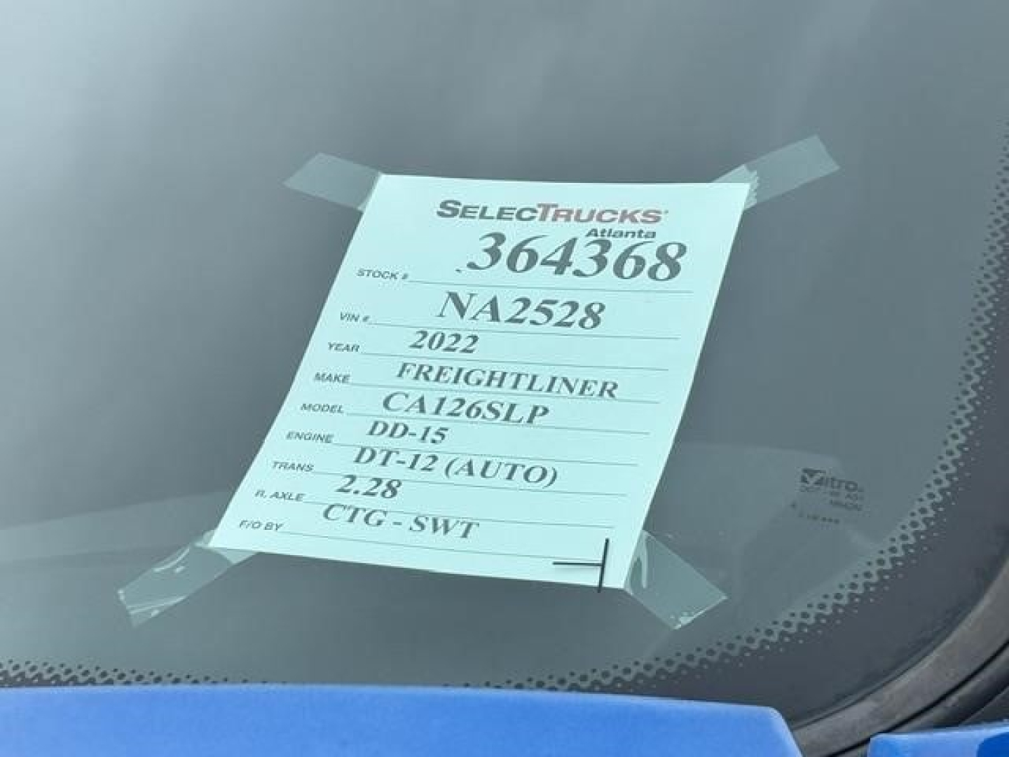 Front windshield tag showing stock number 364368, VIN NA2528, year 2022, make Freightliner, model CA126LP, engine DD-13, transmission DT-12 (Auto), 2.28 rear axle, CTG-SWT.