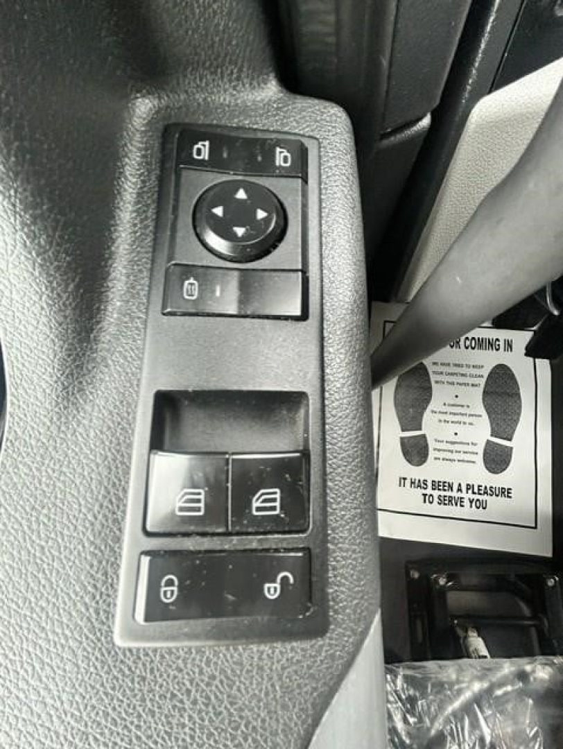 Freightliner Cascadia 126 interior door panel switches for windows, mirrors, and locks.