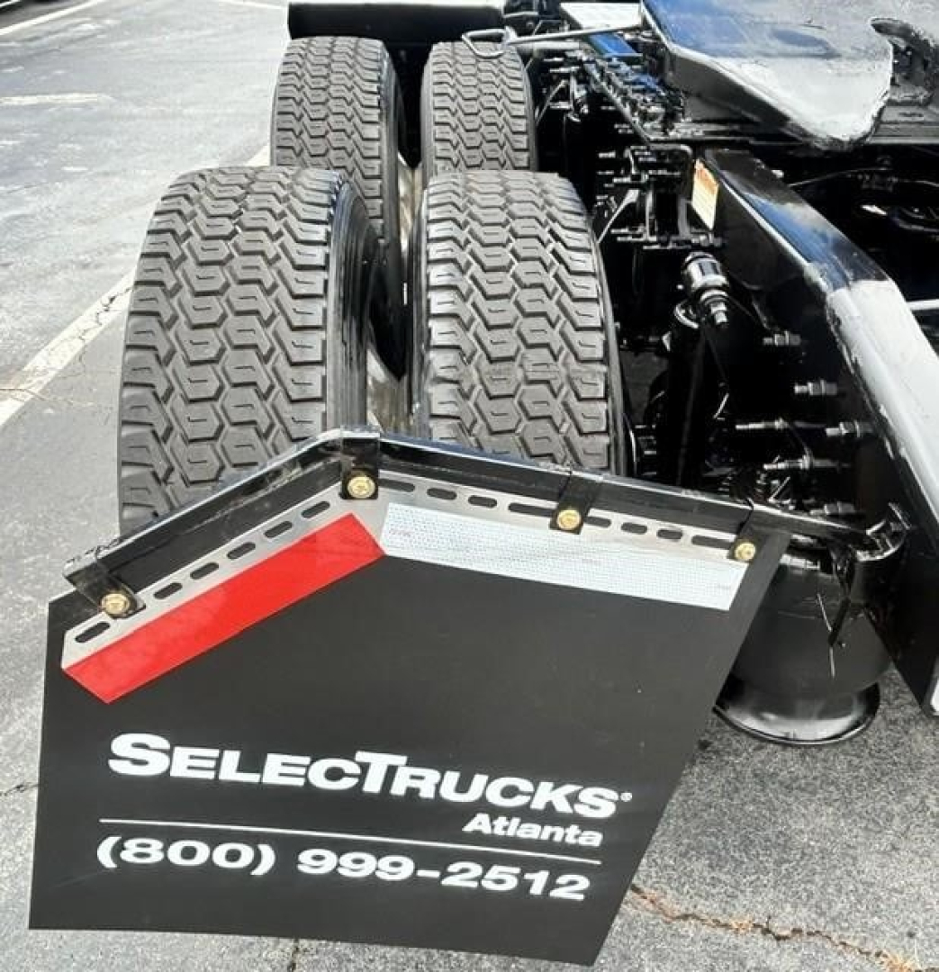 Freightliner Cascadia 126 rear view showing dual rear axles and mudflaps with SelectTrucks Atlanta branding and contact number.