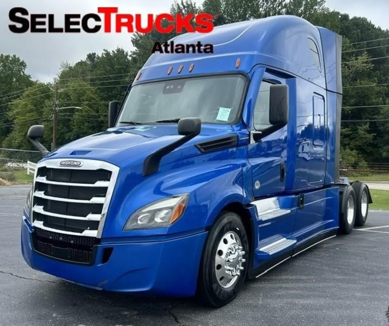 Truck cab in blue showing Freightliner Cascadia 126 with sleeper, front grille, headlights, and side mirrors.