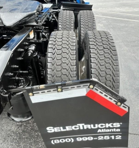 Freightliner Cascadia 126 truck rear view showing dual rear axles and fifth-wheel area with SelectTrucks Atlanta bumper and contact number.