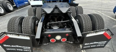 Chassis rear view of a 2022 Freightliner Cascadia 126 tractor showing dual rear axles with six wheels, fifth-wheel mounting, and mud flaps with Select Trucks branding.
