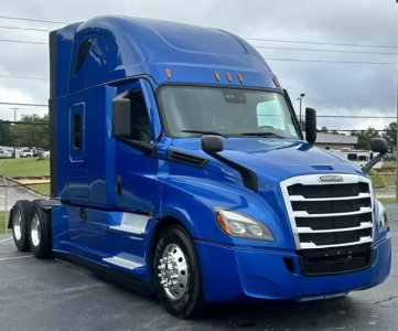Blue Freightliner Cascadia 126 tractor from front-left side with sleeper cab and chrome accents.