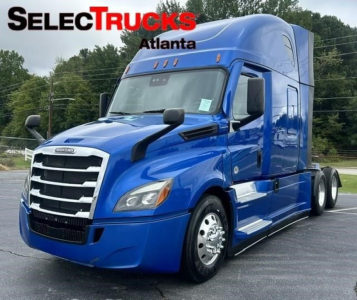 Truck cab in blue showing Freightliner Cascadia 126 with sleeper, front grille, headlights, and side mirrors.