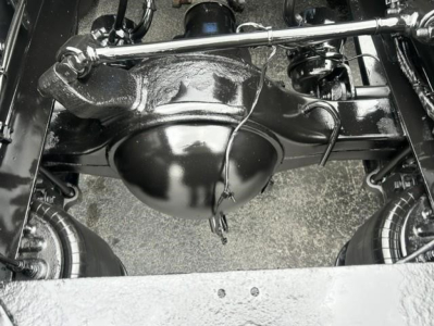 Rear axle differential housing and suspension components in a Freightliner Cascadia engine bay view.