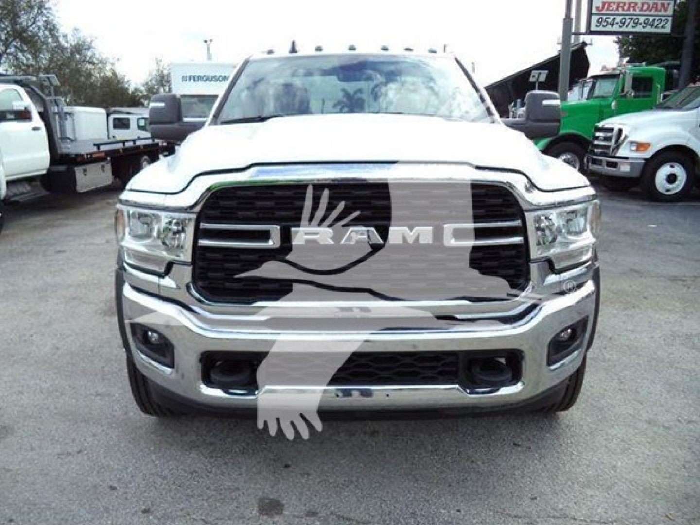 Ram 5500 front view showing chrome grille and RAM emblem, with bumper and headlights visible.