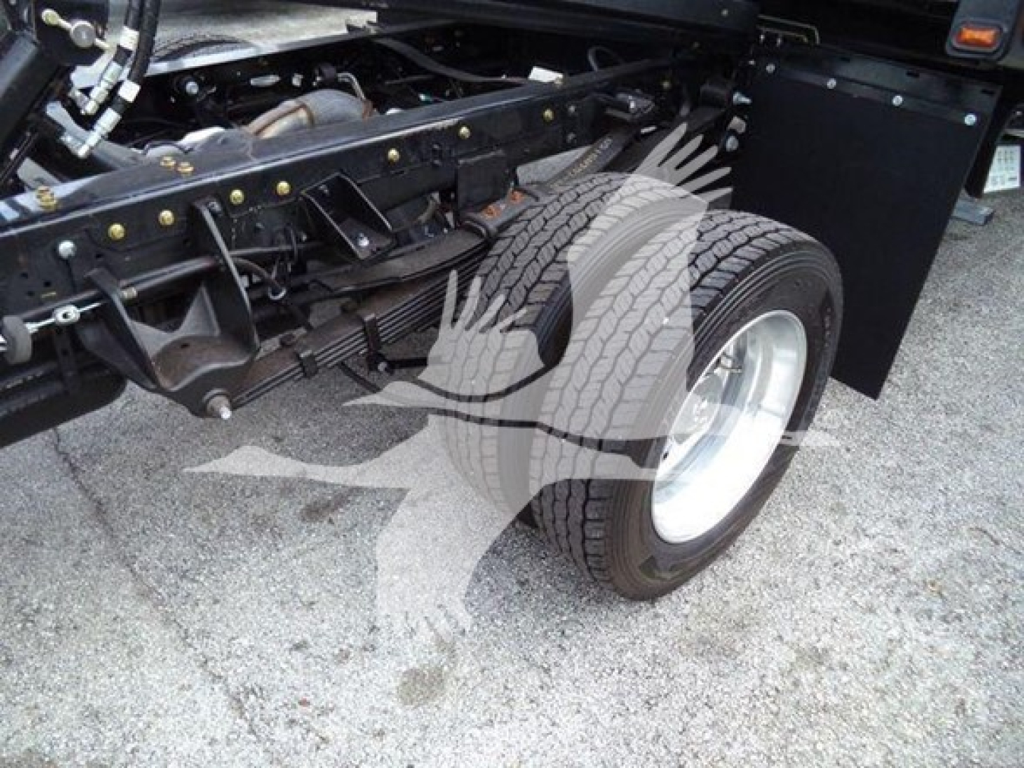 Ram 5500 rollback truck chassis with front suspension and wheel, showing front tire and leaf spring components.