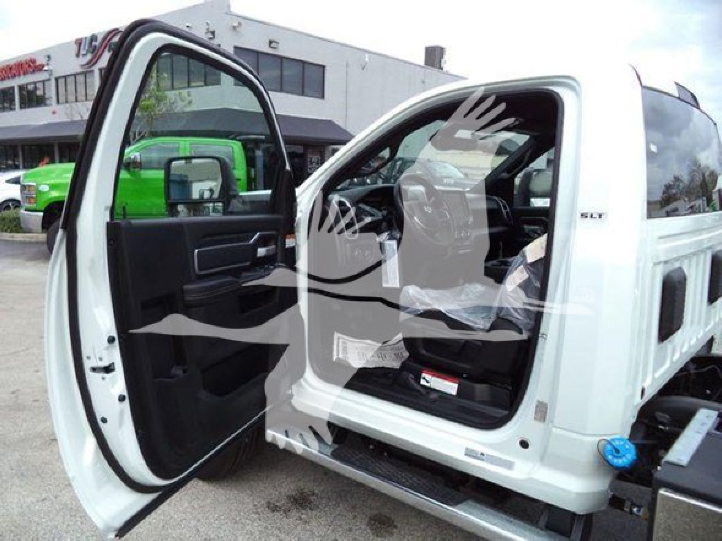 Ram 5500 SLT crew cab with front door open, white body, interior seating visible