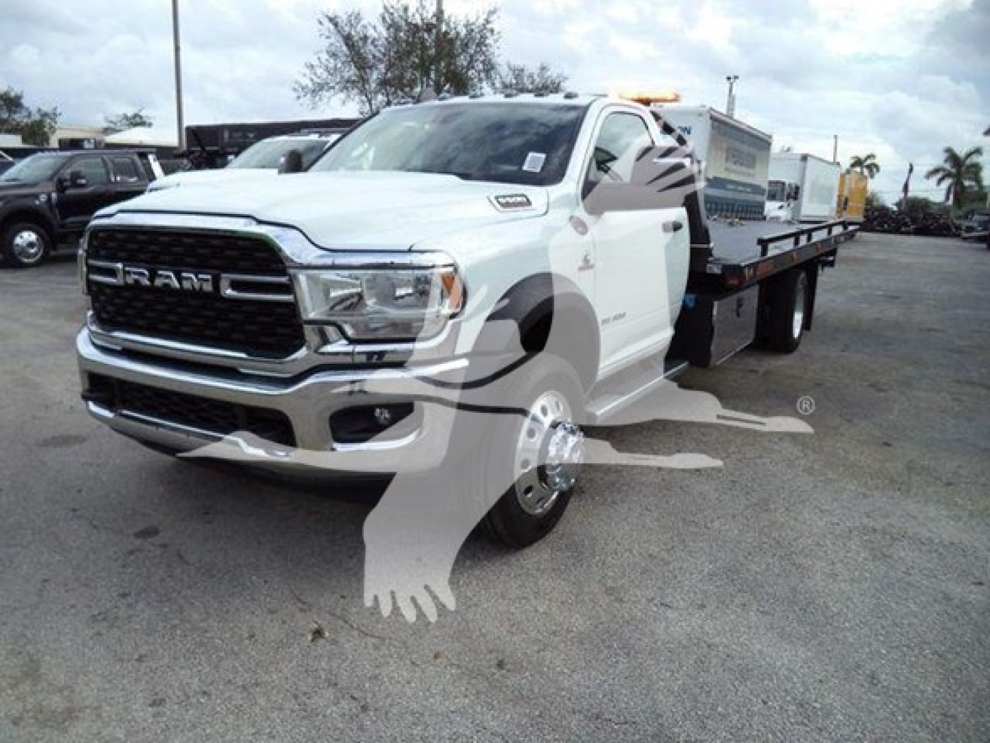 Ram 5500 SLT pickup truck with a flatbed/rollback configuration, white exterior, front grille with RAM badge, visible headlights and chrome bumper.