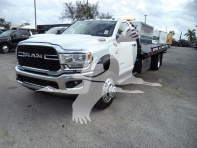 Ram 5500 SLT pickup truck with a flatbed/rollback configuration, white exterior, front grille with RAM badge, visible headlights and chrome bumper.