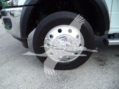 Ram 5500 wheel and chrome hubcap with tire showing front left fender and chrome bumper edge.