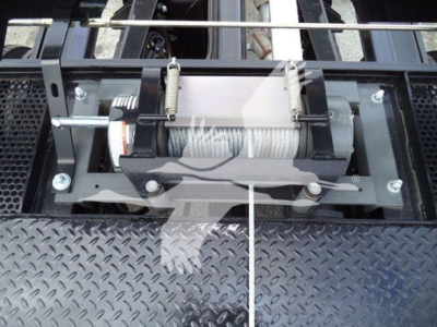 Ram 5500 rollback with winch mechanism and metal diamond plate surface visible.