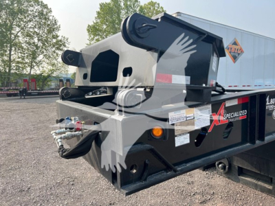 Trailer hitch and hydraulic boom on XL Specialized XL80HDE lowboy trailer showing hydraulic hoses and frame details.