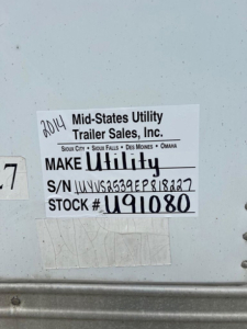 Tag on trailer showing 2014 Mid-States Utility Trailer Sales, Inc. Make Utility, S/N 1UYVS2539EP818227, Stock # U91080, VIN 2014
