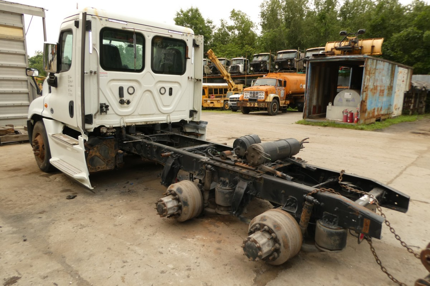 Freightliner Cascadia 125 tractor cab with exposed chassis and rear axle assemblies in an outdoor lot.