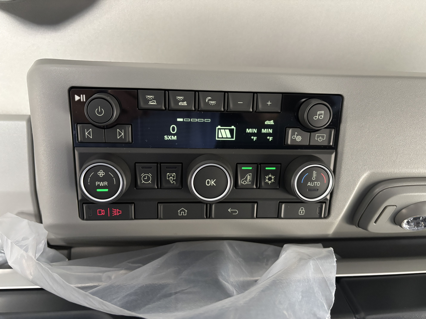 Volvo VNL dashboard controls with digital display and multiple buttons in the center console.