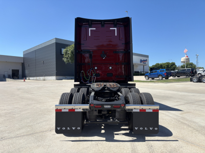 Volvo truck rear view showing fifth wheel, dual rear axles, and mud flaps with Volvo branding.