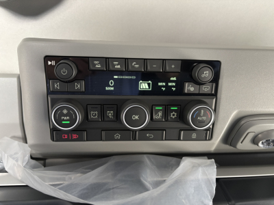 Volvo VNL dashboard controls with digital display and multiple buttons in the center console.