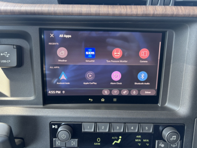 Volvo VNL64T860 dashboard touchscreen displaying apps and control buttons.