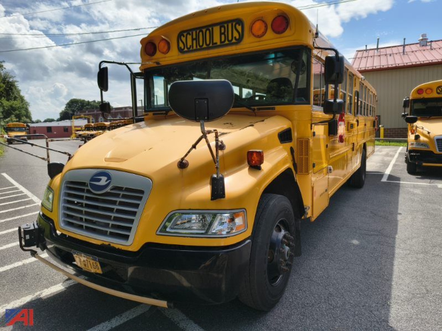 Bus front view of a yellow 2016 Blue Bird Vision school bus with black bumper, front grille, and school bus sign on the roof.