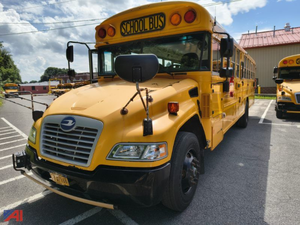 Bus front view of a yellow 2016 Blue Bird Vision school bus with black bumper, front grille, and school bus sign on the roof.