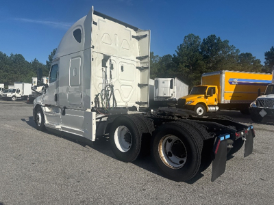 Concrete Freightliner Cascadia126 tractor truck cab and chassis showing side view with fifth wheel and dual rear axles.