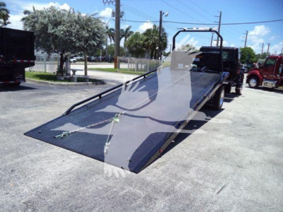 Tow truck rollback bed attached to a 2026 Hino L6 cab and chassis, flatbed with ramp, VIN 5PVNJ7ET5T5T50133 visible, stock J50133.