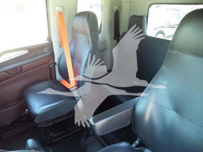 Interior of a new 2026 Hino L6 rollback truck showing two front seats with orange seatbelt and a fold-down middle seat.