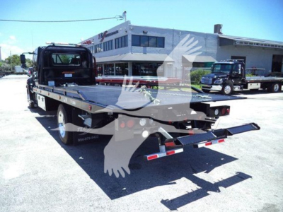 Hino L6 rollback truck bed with flatbed and rear ramps.