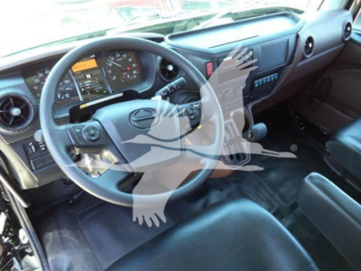 Truck cab interior showing steering wheel, dashboard gauges, and driver's seat in a new Hino L6 rollback truck.
