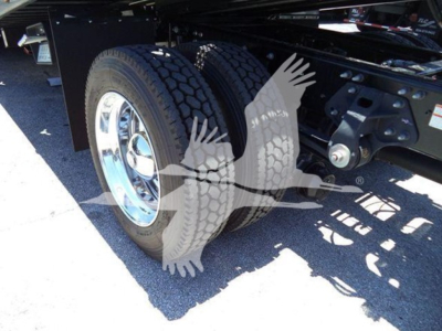 Trucks undercarriage showing dual rear wheels and suspension components.