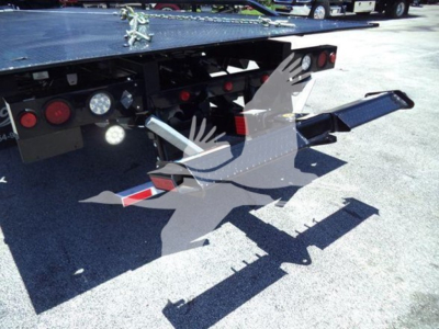 Tow truck flatbed rear with hydraulic ramp and(DKO) loading equipment, visible lights and warning reflectors.