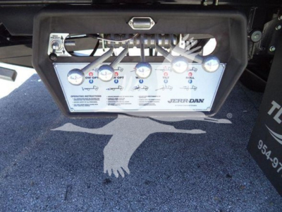 Hino L6 equipment panel showing multiple gauges and control labels with brand Jerr-Dan. Visible labels include operating instructions and valve indicators.