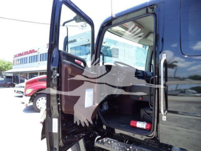 Truck cab interior open door showing dashboard and empty passenger seat with a fire extinguisher in the side compartment.