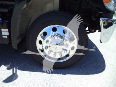 Truck wheel and fender with chrome hubcap visible; no legible text other than partial vehicle parts.