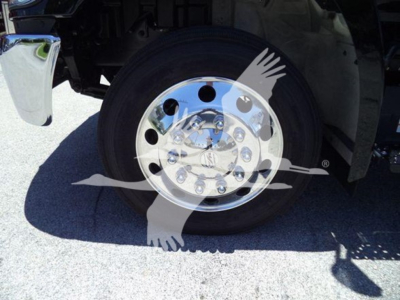 Truck wheel and chrome hub showing front tire and fender with reflection; branding watermark overlay across the wheel.