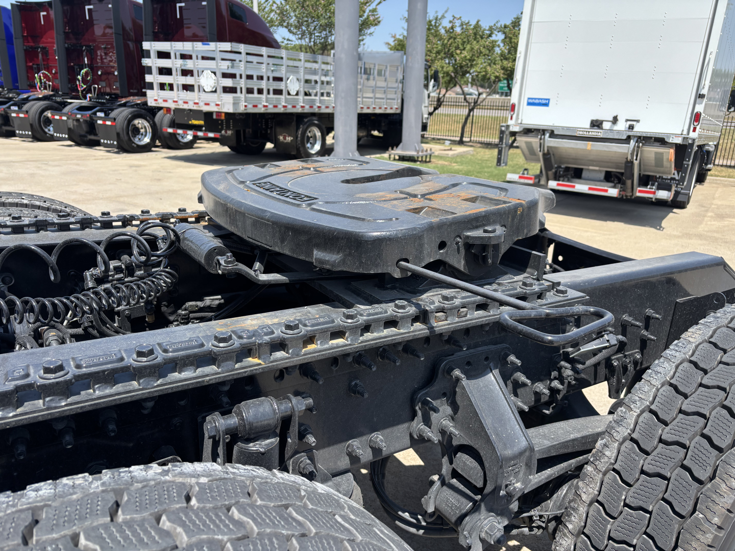 Mack PR64T76H tractor cab chassis showing fifth wheel area and drive components with dual rear tires and frame rails.