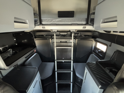 Interior of new 2027 Mack PR64T76H sleeper cab showing upper bunk area and ladder connecting to lower cabin.