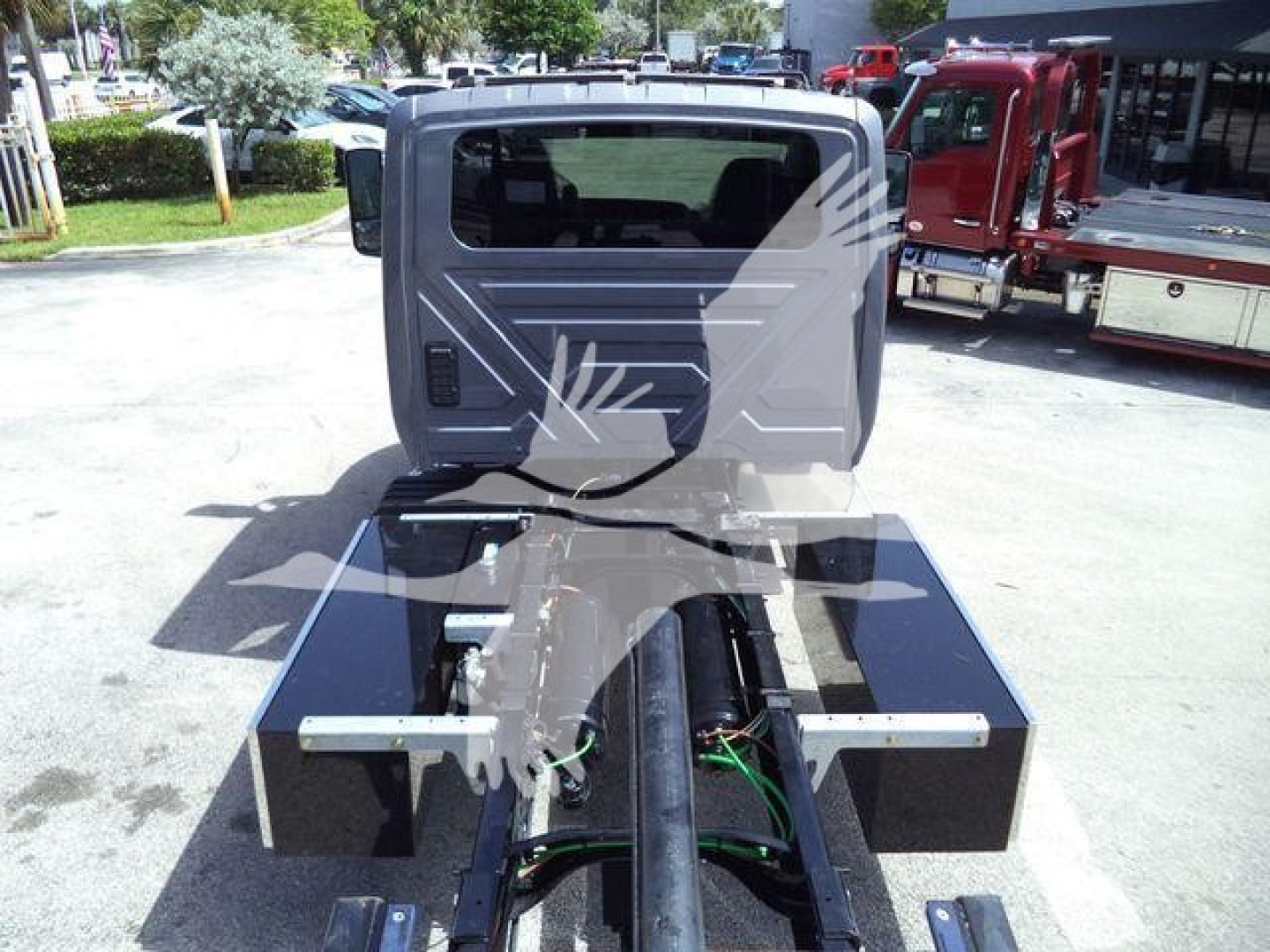 International MV rollback truck cab and chassis showing frame rails and mounting points with hydraulic lines.