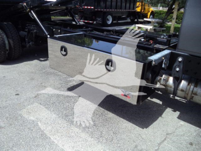 Aluminum toolbox mounted on truck chassis with handles and pad in view.