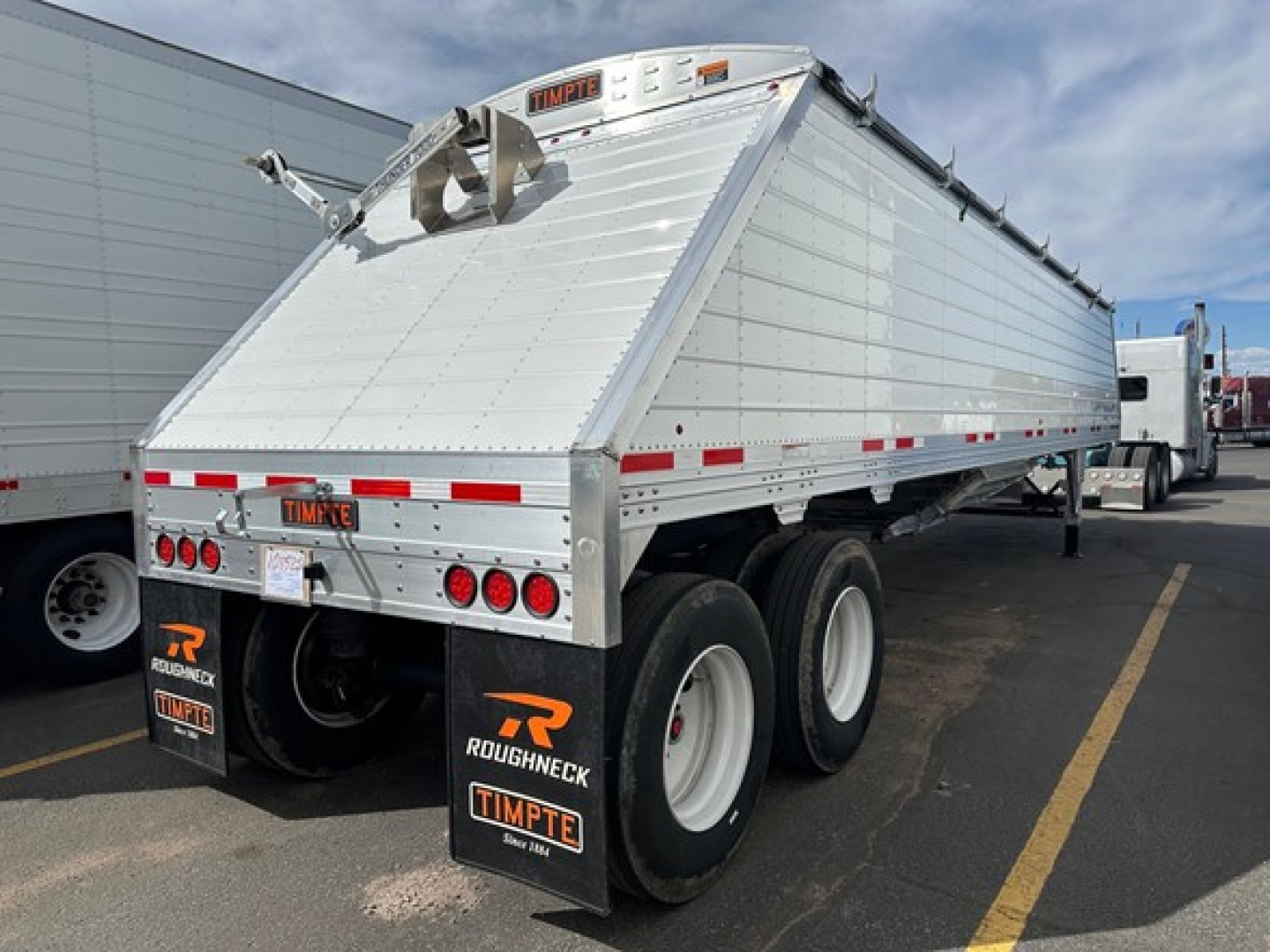 Timpte frac sand hopper trailer rear view showing aluminum body, dual rear axles, and mud flaps with Timpte branding.