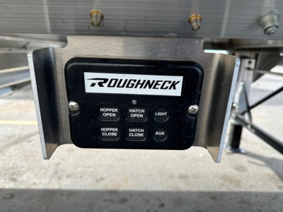 Roughneck control panel mounted on hopper trailer showing buttons: Hopper Open, Hatch Open, Light, Hopper Close, Hatch Close, Aux.